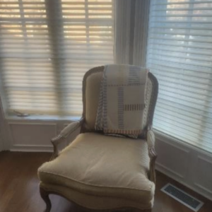 Louis style cream chair with carved wood frame and upholstered seat