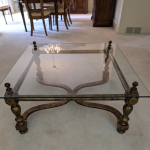 Vintage coffee table with carved wood base and classic detailing
