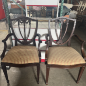 Pair of wood shield-back armchairs with striped upholstered seats.