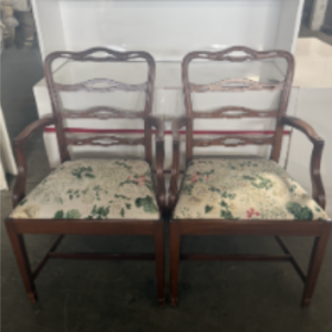 Pair of vintage wood armchairs with decorative ladder backs and floral upholstered seats.