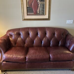 Burgundy tufted leather sofa.