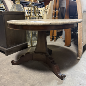 Round table with stone top and wood pedestal base