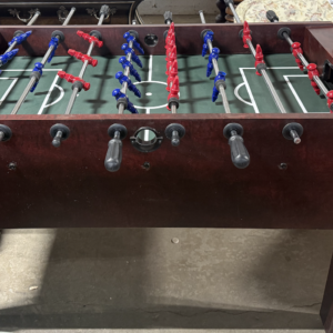 Foosball table with wood finish and red and blue players