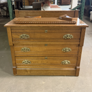 Eastlake style oak dresser with carved details and brass hardware