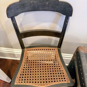 Wood chair with woven cane seat and classic curved back.