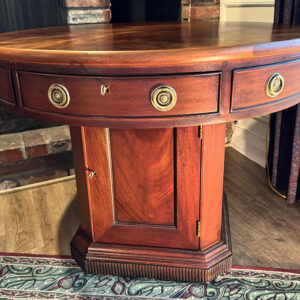 Round mahogany drum table with drawers and cabinet base