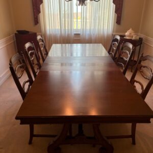 Wood dining table with matching chairs.
