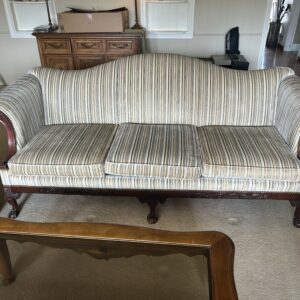 Striped vintage sofa with carved wood arms and legs.